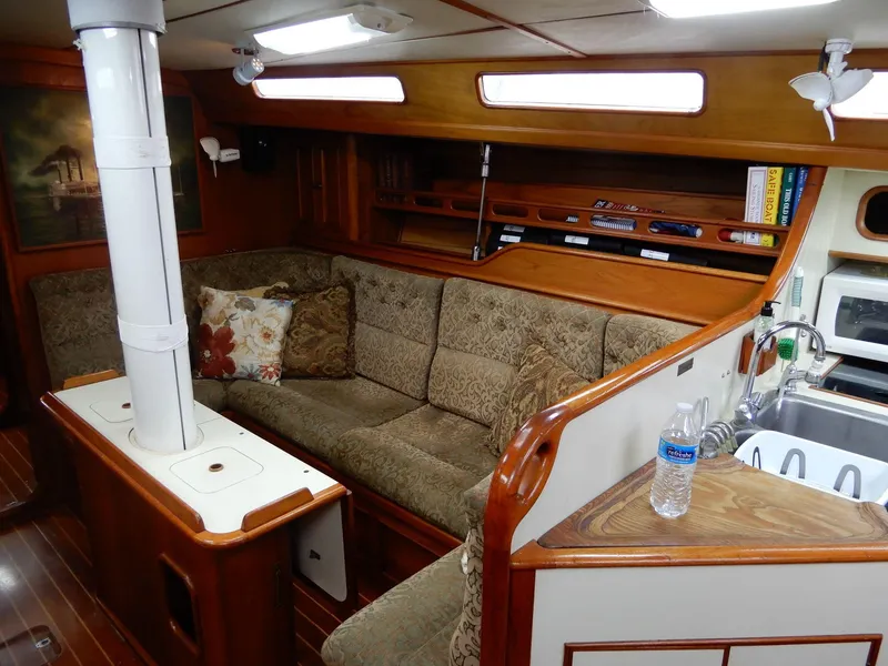 Slide: The Image of Cozy interior of a 1985 Barnett Offshore yacht with plush seating and wooden accents. - 4