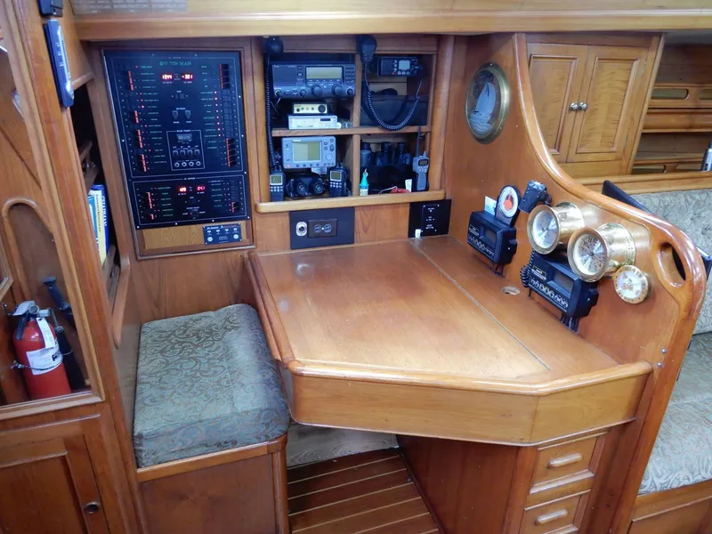 Slide: The Image of Navigation station of a 1985 Barnett Offshore yacht with instruments and wooden cabinetry. - 9