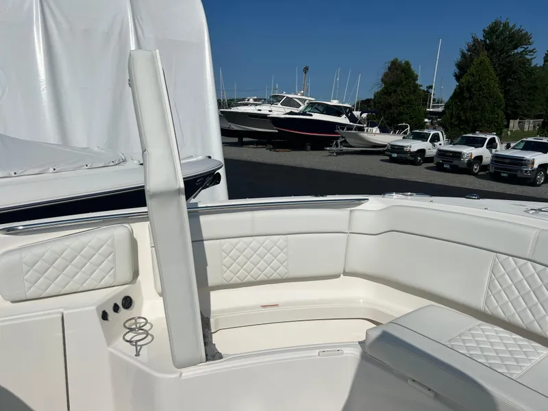 Slide: The Image of 2024 Pursuit S 328 Sport boat interior with white cushioned seating and diamond stitching. - 11