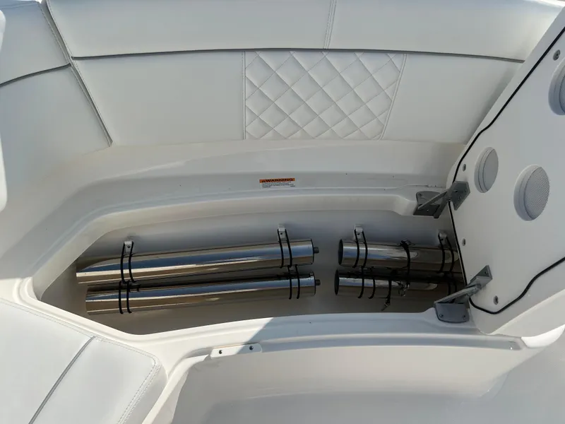 Slide: The Image of 2024 Pursuit S 328 Sport boat storage compartment with stainless steel rods. - 12