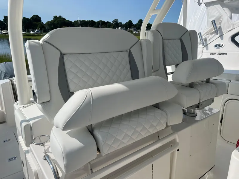 Slide: The Image of Luxurious seating on 2024 Pursuit S 328 Sport boat, featuring quilted white upholstery. - 14