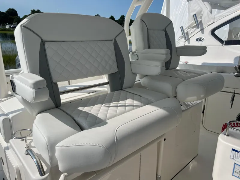 Slide: The Image of 2024 Pursuit S 328 Sport boat with luxurious white seating and quilted design. - 15