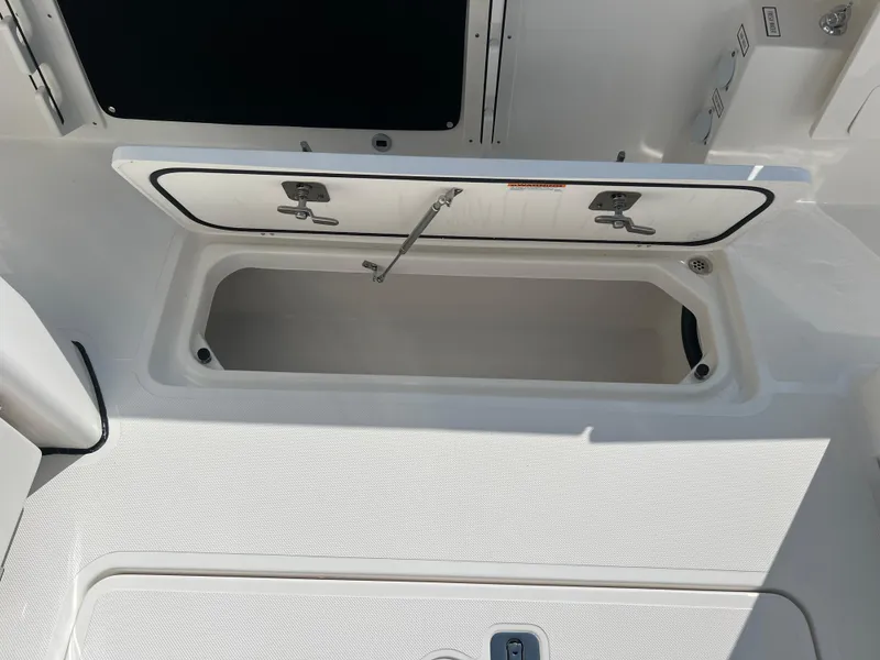 Slide: The Image of Open storage compartment on 2024 Pursuit S 328 Sport boat deck. - 22