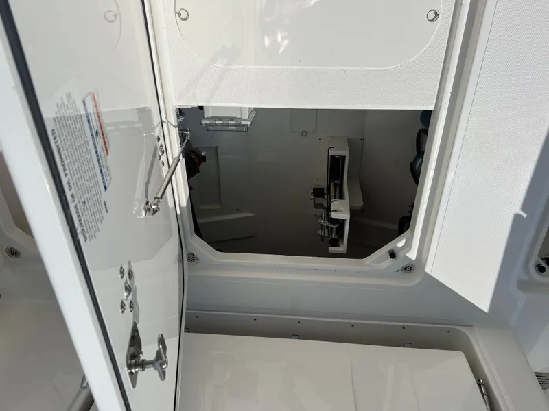 Slide: The Image of 2024 Pursuit S 328 Sport boat interior storage compartment with open hatch. - 23