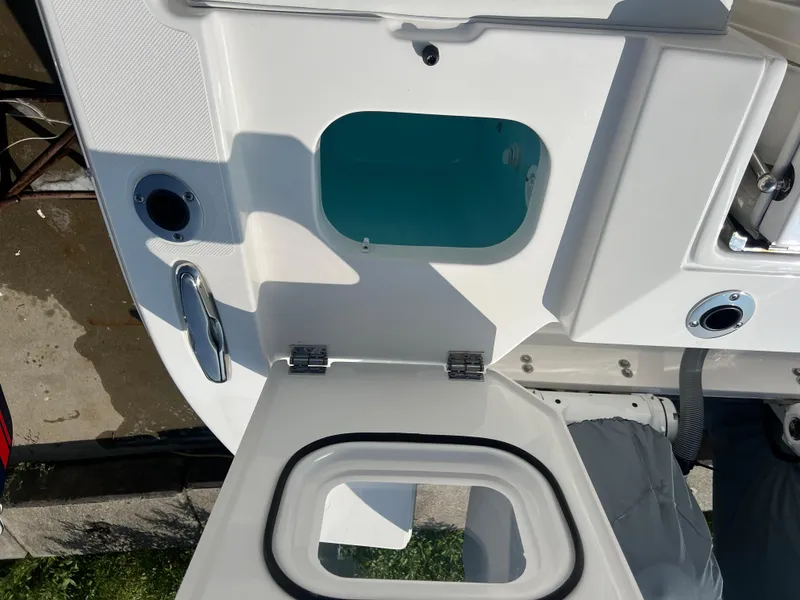 Slide: The Image of 2024 Pursuit S 328 Sport boat interior with open hatch and storage compartment. - 24