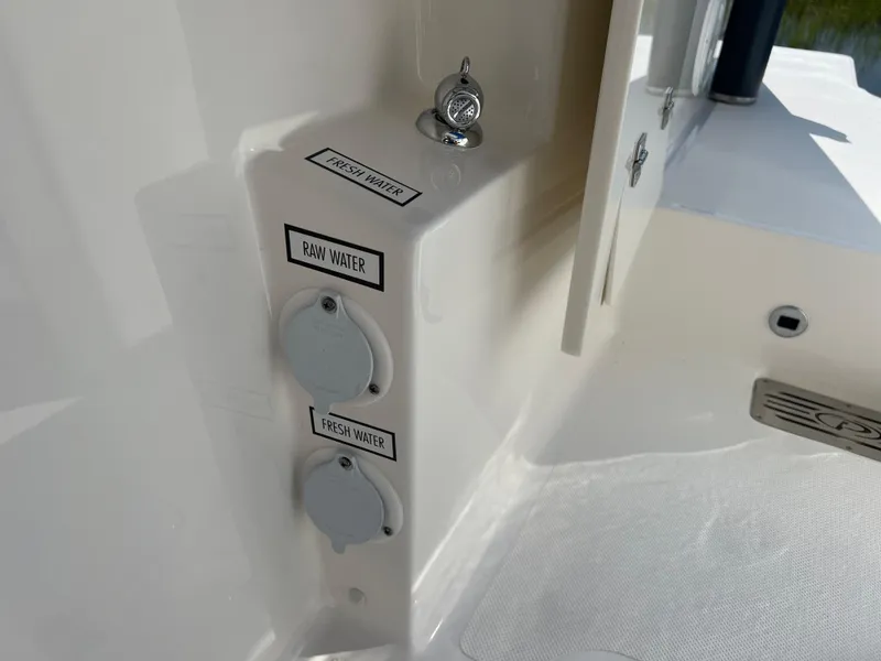 Slide: The Image of 2024 Pursuit S 328 Sport boat water outlets labeled raw and fresh water. - 29