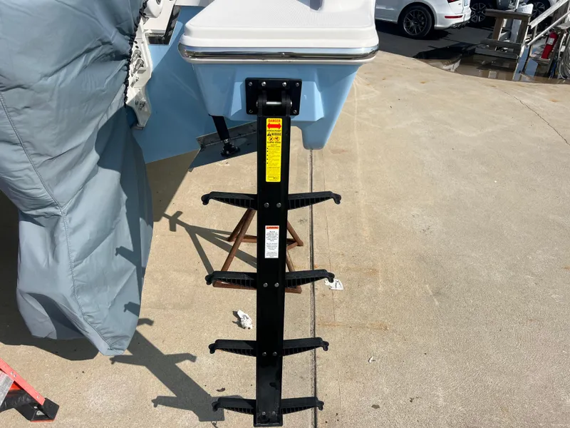 Slide: The Image of 2024 Pursuit S 328 Sport boat ladder on concrete surface, partially covered. - 3