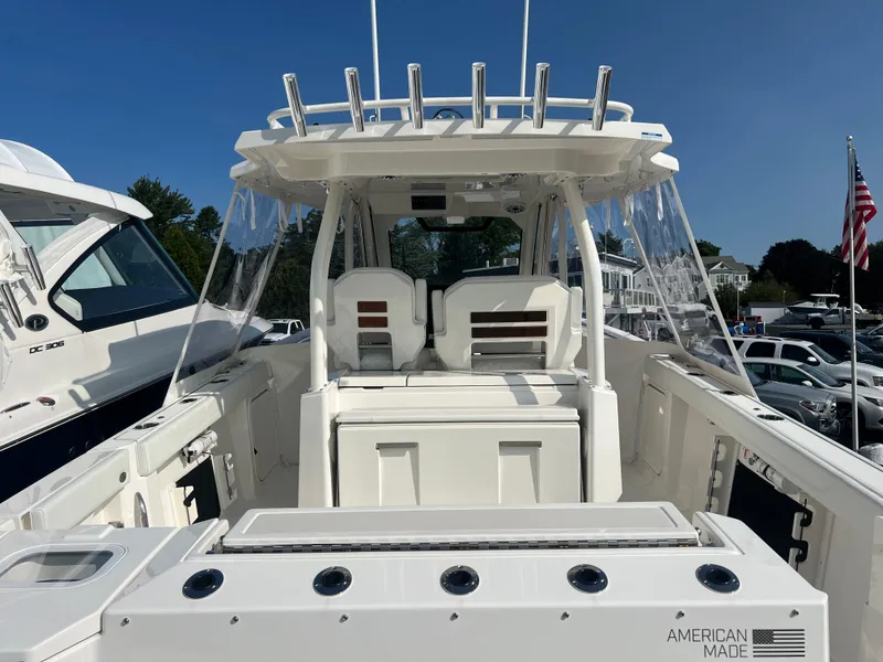 Slide: The Image of 2024 Pursuit S 328 Sport boat, American-made, featuring a sleek white design and spacious deck. - 7