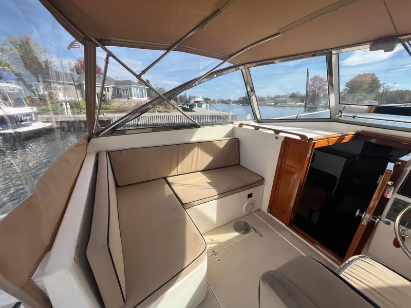 Slide: The Image of Interior of 2000 Bruckmann Bluestar 29.9 boat with beige seating and wooden accents. - 16