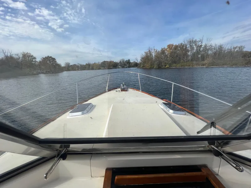 Slide: The Image of View from the helm of a 2000 Bruckmann Bluestar 29.9 boat cruising on a calm river. - 17