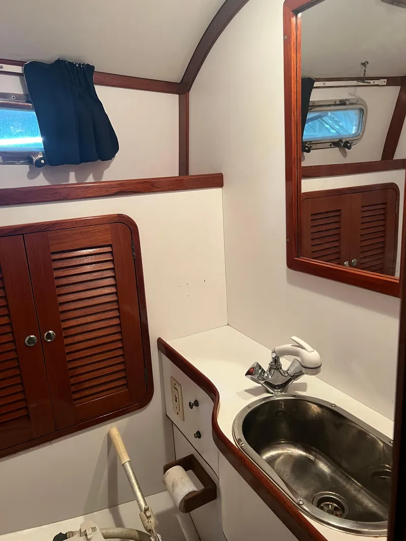 Slide: The Image of Boat bathroom interior of 2000 Bruckmann Bluestar 29.9 with sink and wooden cabinets. - 26