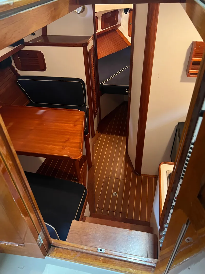 Slide: The Image of Interior of 2000 Bruckmann Bluestar 29.9 boat with wooden finishes and seating area. - 27