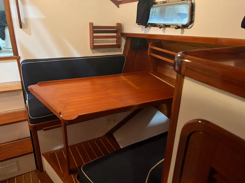 Slide: The Image of Interior of 2000 Bruckmann Bluestar 29.9 with wooden table and seating area. - 30