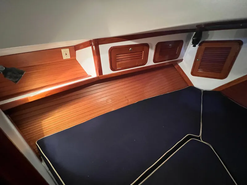 Slide: The Image of Interior cabin of 2000 Bruckmann Bluestar 29.9 with wooden paneling and navy cushions. - 32