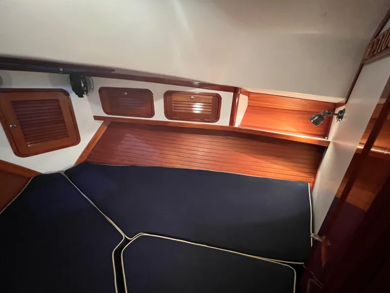 Slide: The Image of Interior cabin of a 2000 Bruckmann Bluestar 29.9 boat with wooden finishes and blue cushions. - 33