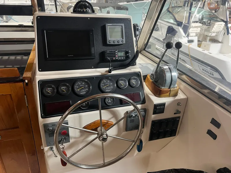 Slide: The Image of Helm station of a 2000 Bruckmann Bluestar 29.9 boat with steering wheel and control panel. - 35