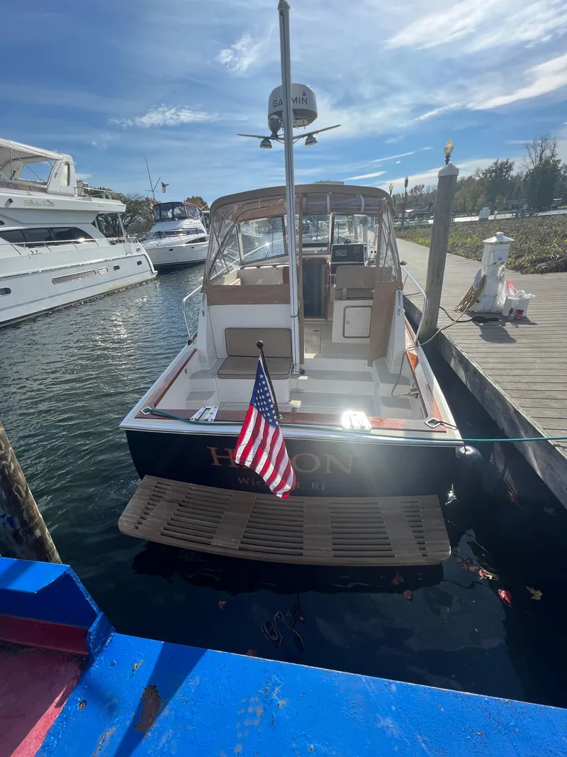 Slide: The Image of Alt text: 2000 Bruckmann Bluestar 29.9 boat docked at marina with American flag. - 9