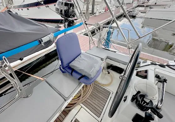 Slide: The Image of Cockpit of 2019 Beneteau Oceanis 48 sailboat with steering wheel and seating. - 10