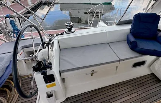 Slide: The Image of Cockpit of 2019 Beneteau Oceanis 48 sailboat with seating and steering wheel. - 12