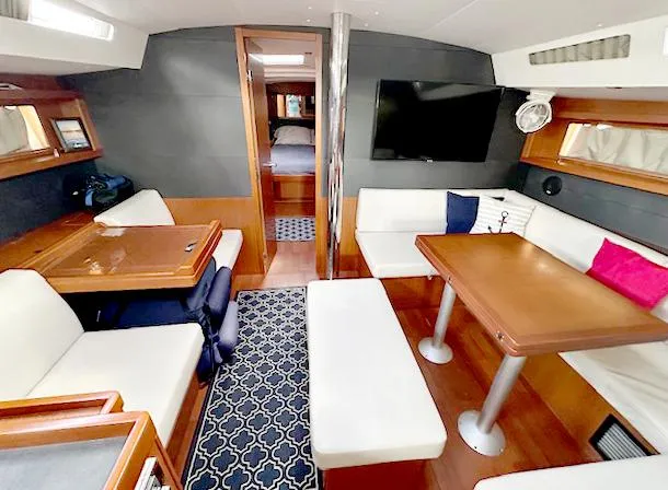 Slide: The Image of Interior of 2019 Beneteau Oceanis 48 yacht with modern seating and dining area. - 18