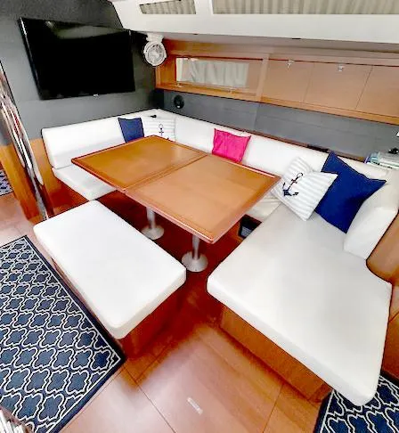 Slide: The Image of Interior of 2019 Beneteau Oceanis 48 yacht with elegant seating and dining area. - 23