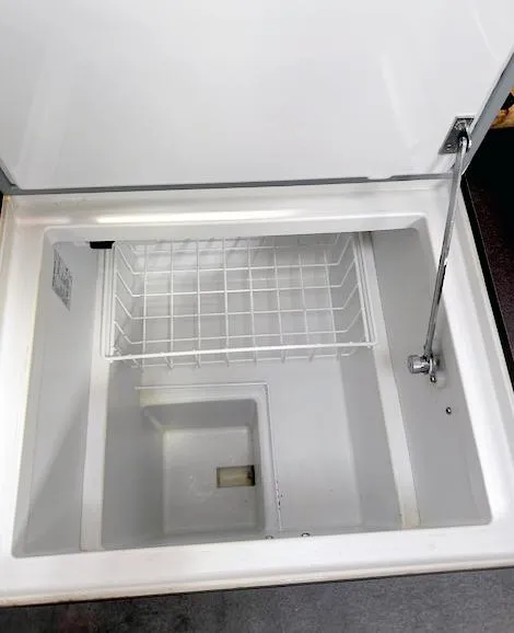 Slide: The Image of Open storage compartment on 2019 Beneteau Oceanis 48 yacht, featuring a wire basket. - 28