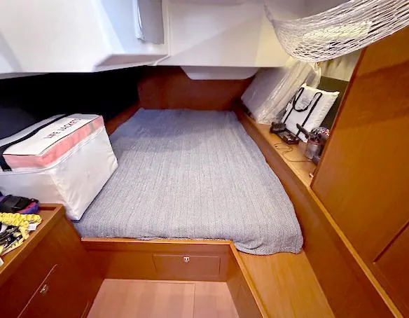 Slide: The Image of Cozy cabin interior of 2019 Beneteau Oceanis 48 sailboat with bed and storage. - 34