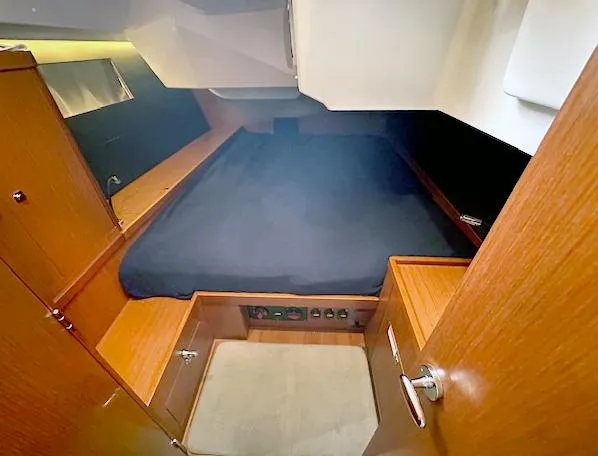 Slide: The Image of 2019 Beneteau Oceanis 48 cabin interior with wooden finish and cozy bed. - 35