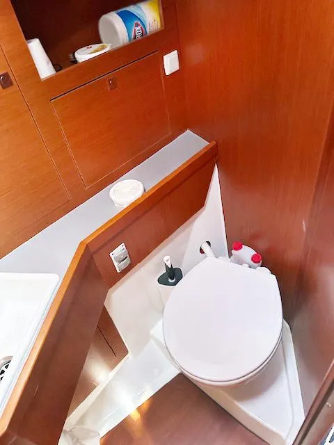 Slide: The Image of 2019 Beneteau Oceanis 48 yacht bathroom with wooden cabinetry and modern fixtures. - 40
