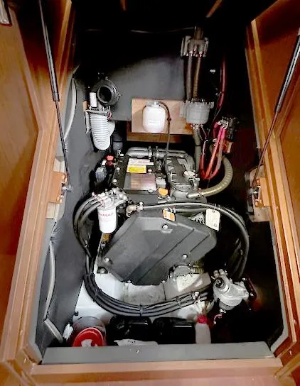 Slide: The Image of Engine compartment of 2019 Beneteau Oceanis 48 sailboat, showcasing mechanical components and wiring. - 42