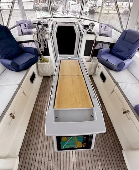 Slide: The Image of 2019 Beneteau Oceanis 48 yacht cockpit with seating, table, and nautical equipment. - 5