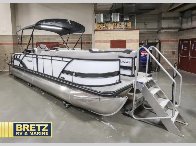 Slide: The Image of 2024 L-F DLZ BAR pontoon boat displayed indoors at Bretz RV & Marine showroom. - 1