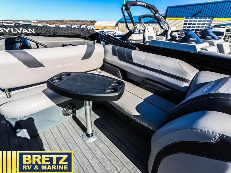Slide: The Image of Luxury seating area on a 2024 Sylvan pontoon boat at Bretz RV & Marine. - 13