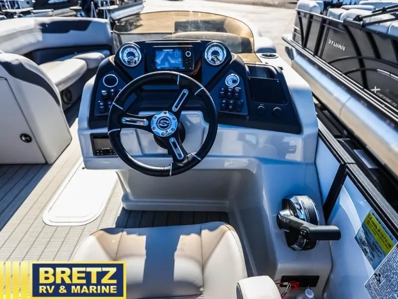 Slide: The Image of 2024 L-F DLZ BAR boat dashboard with steering wheel and controls at Bretz RV & Marine. - 14