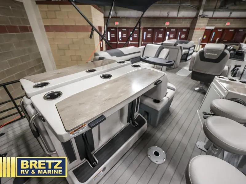 Slide: The Image of 2024 L-F DLZ BAR boat interior with seating and tables at Bretz RV & Marine showroom. - 20