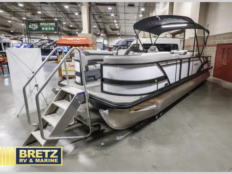 Slide: The Image of 2024 L-F DLZ BAR pontoon boat displayed indoors at Bretz RV & Marine showroom. - 6