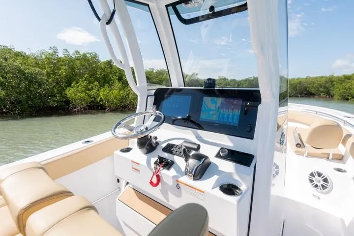 Slide: The Image of 2024 Sportsman Open 282 boat console with dual screens and steering wheel. - 2