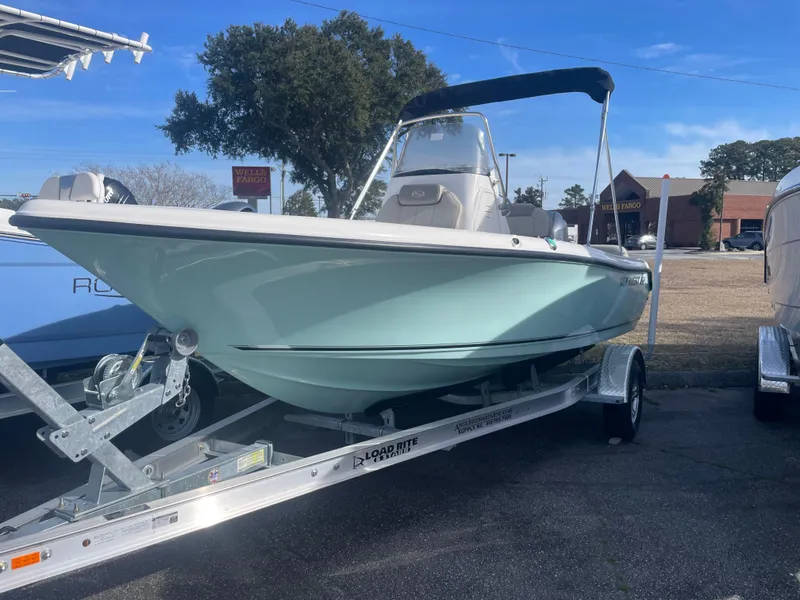 Slide: The Image of 2024 Key West 189 FS boat on trailer, light blue hull, parked outdoors. - 0