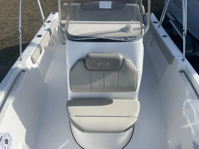 Slide: The Image of 2024 Key West 189 FS boat interior with cushioned seating and console. - 12
