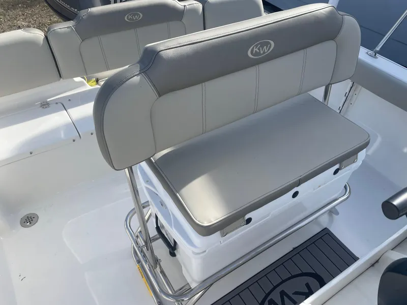 Slide: The Image of 2024 Key West 189 FS boat interior with cushioned seating and storage. - 6
