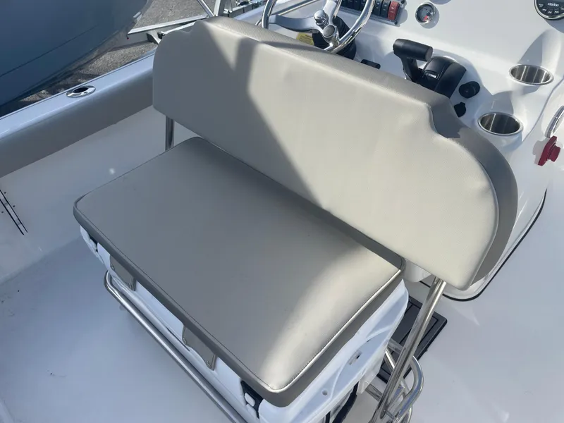 Slide: The Image of 2024 Key West 189 FS boat interior with cushioned seating and console. - 7
