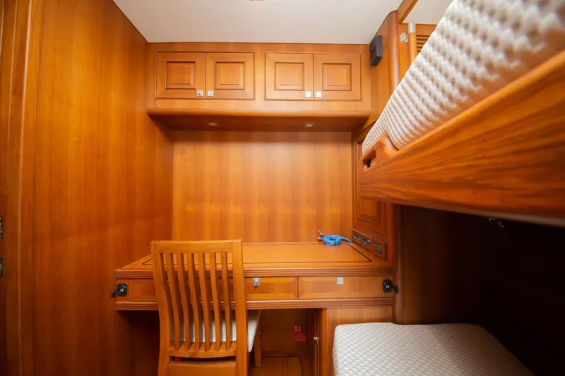 Slide: The Image of Cozy wooden cabin interior with desk and bunk bed on Selene 60 Classic Explorer, 2026 model. - 16