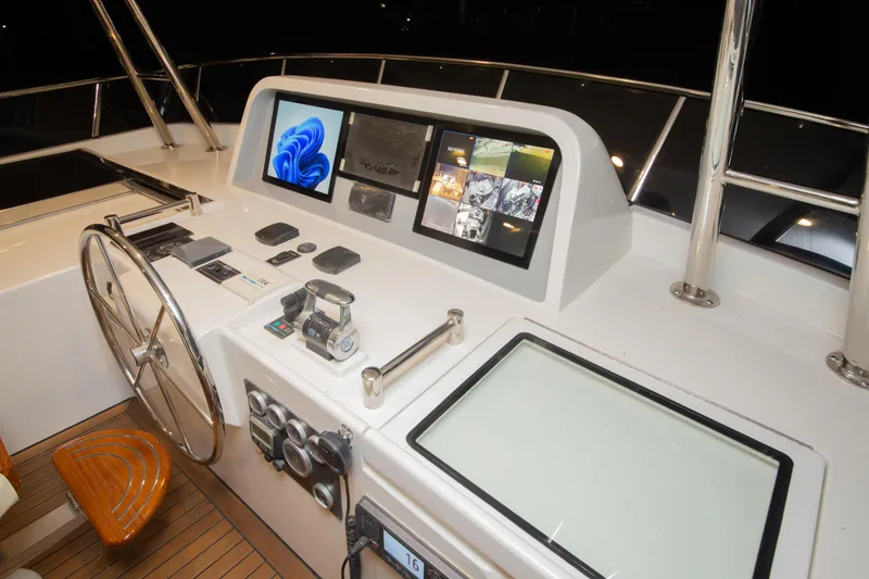 Slide: The Image of Helm of 2026 Selene 60 Classic Explorer with modern navigation displays and controls. - 23