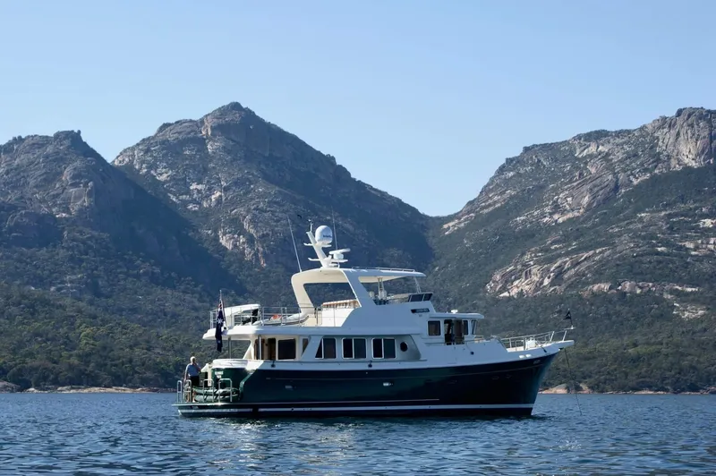 Slide: The Image of Selene 60 Classic Explorer yacht cruising near scenic mountains, 2026 model. - 3