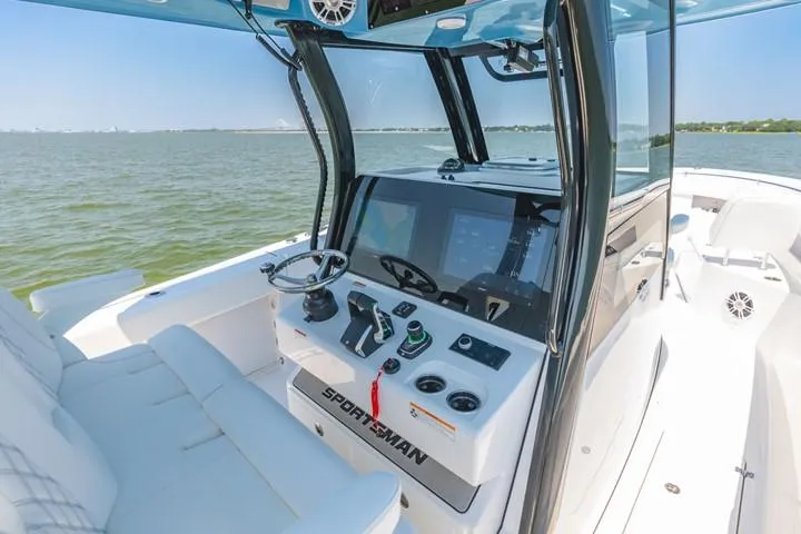 Slide: The Image of 2024 Sportsman Open 322 boat interior with modern dashboard and steering wheel. - 5