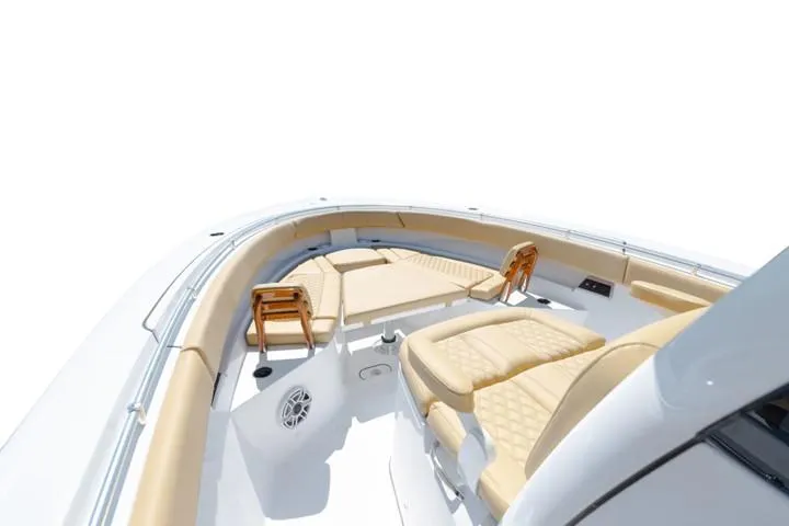 Slide: The Image of 2024 Sportsman Open 322 boat interior with tan seating and white deck. - 9