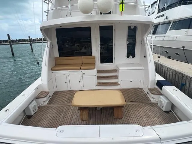 Slide: The Image of Bertram 670 2004 model yacht with spacious deck and seating area in marina. - 22