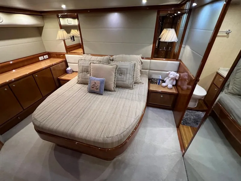 Slide: The Image of Luxurious bedroom interior of a 2004 Bertram 670 yacht with cozy bed and elegant decor. - 34