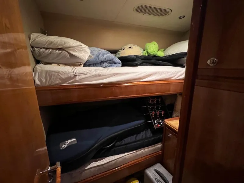 Slide: The Image of Bertram 670 2004 model cabin with bunk beds and storage. - 40