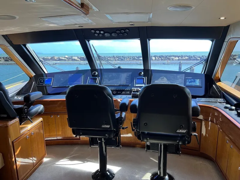 Slide: The Image of Interior helm of a 2004 Bertram 670 yacht with panoramic windows. - 46